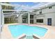Exterior view of the screened-in pool and backyard of home at 16003 Ridley Pl, Tampa, FL 33647
