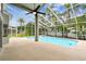 A screened-in pool and spacious patio surrounded by lush landscaping, perfect for relaxation and outdoor entertainment at 16003 Ridley Pl, Tampa, FL 33647