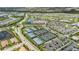Overhead shot of a community's tennis courts, clubhouse, and a lake at 16126 San Donato Pl, Bradenton, FL 34211