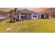 Expansive backyard featuring lush green grass, a screened-in lanai, and well-maintained landscaping at 16126 San Donato Pl, Bradenton, FL 34211