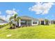 Spacious backyard featuring lush green lawn and a screened-in porch, ideal for outdoor living at 16126 San Donato Pl, Bradenton, FL 34211
