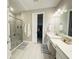 Modern bathroom with glass-enclosed shower, single vanity, and walk-in closet at 16126 San Donato Pl, Bradenton, FL 34211