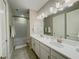 Bright bathroom with double sinks, modern vanity, and shower over bath at 16126 San Donato Pl, Bradenton, FL 34211