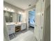 Bright bathroom features double vanity, tiled floors and a walk-in glass shower at 16126 San Donato Pl, Bradenton, FL 34211