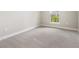 Neutral bedroom with carpeted floors and a bright window offering natural light at 16126 San Donato Pl, Bradenton, FL 34211