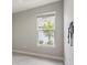 Light bright bedroom with a window offering natural light, alongside a wall-mounted TV at 16126 San Donato Pl, Bradenton, FL 34211