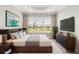 Comfortable bedroom with a large window overlooking a serene pond view at 16126 San Donato Pl, Bradenton, FL 34211