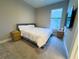Comfortable bedroom with a queen-size bed, bedside tables, and a large window for natural light at 16126 San Donato Pl, Bradenton, FL 34211