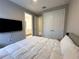 Bedroom with a view to the ensuite bathroom, featuring a large closet and ceiling fan at 16126 San Donato Pl, Bradenton, FL 34211