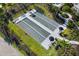 Aerial view of bocce ball courts surrounded by palm trees and landscaped pathways at 16126 San Donato Pl, Bradenton, FL 34211