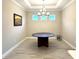 Formal dining room featuring modern chandelier and tile flooring at 16126 San Donato Pl, Bradenton, FL 34211