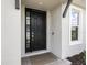 Contemporary black front door with sidelight and neutral-toned exterior at 16126 San Donato Pl, Bradenton, FL 34211