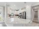 Bright kitchen with white cabinets, stainless steel appliances, quartz countertops and gray tiled flooring at 16126 San Donato Pl, Bradenton, FL 34211