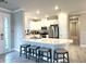 This modern kitchen features a large island with bar seating, sleek countertops, and stainless steel appliances at 16126 San Donato Pl, Bradenton, FL 34211