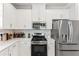 Well-equipped kitchen featuring stainless steel appliances, granite countertops, and white cabinets and subway tile backsplash at 16126 San Donato Pl, Bradenton, FL 34211