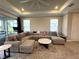 Cozy living room with comfortable seating, natural light, and a modern ceiling fan at 16126 San Donato Pl, Bradenton, FL 34211
