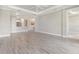 Spacious living room featuring tile floors, neutral paint, and an open floor plan leading into the kitchen at 16126 San Donato Pl, Bradenton, FL 34211