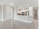 Open concept living area with tile floors, neutral paint, and a half wall separating the living area from kitchen at 16126 San Donato Pl, Bradenton, FL 34211