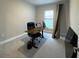 Bright office space featuring a large desk, ergonomic chair, and natural light from the window at 16126 San Donato Pl, Bradenton, FL 34211