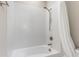 Clean white tiled shower and tub combination featuring a chrome shower head at 16126 San Donato Pl, Bradenton, FL 34211