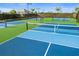 Close-up of blue and green tennis court with net and well-maintained playing surface at 16126 San Donato Pl, Bradenton, FL 34211