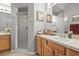 Bathroom with glass shower, oak vanity, and ample counter space for toiletries at 1827 Hammocks Ave # 1303, Lutz, FL 33549