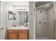 Bright bathroom with a single sink vanity and a tiled shower with a glass door at 1827 Hammocks Ave # 1303, Lutz, FL 33549