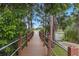 Charming wood dock with safety rails offering a tranquil view of the calm water at 1827 Hammocks Ave # 1303, Lutz, FL 33549