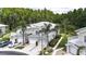 Exterior view of townhomes featuring two-car garages, balconies, and lush tropical landscaping at 1827 Hammocks Ave # 1303, Lutz, FL 33549