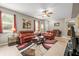 Inviting living room featuring tile flooring, leather sofas, and plenty of natural light at 1827 Hammocks Ave # 1303, Lutz, FL 33549