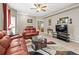 Comfortable living room with neutral walls, ceiling fan, tile flooring, and leather furniture at 1827 Hammocks Ave # 1303, Lutz, FL 33549