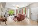 Spacious living room with neutral walls, tile flooring, and access to screened porch at 1827 Hammocks Ave # 1303, Lutz, FL 33549
