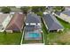 Aerial view of a home showcasing the backyard screened in pool and fenced backyard at 20109 Bay Cedar Ave, Tampa, FL 33647