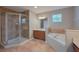 Bathroom showcasing a walk-in shower, corner soaking tub, and tiled floor at 20109 Bay Cedar Ave, Tampa, FL 33647