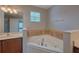 Bathroom featuring a corner tub and vanity with a window that provides natural light at 20109 Bay Cedar Ave, Tampa, FL 33647