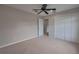 Bedroom featuring carpet, ceiling fan, closet with sliding doors, window with blinds, and neutral walls at 20109 Bay Cedar Ave, Tampa, FL 33647