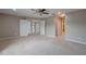 Spacious carpeted bedroom with a ceiling fan, neutral paint, and access to the upper level of the home at 20109 Bay Cedar Ave, Tampa, FL 33647