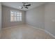 Neutral bedroom with large window, tile floor, and a ceiling fan at 20109 Bay Cedar Ave, Tampa, FL 33647