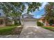 Charming two-story home featuring an attached two-car garage and mature trees at 20109 Bay Cedar Ave, Tampa, FL 33647