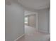 Hallway with doorway to carpeted bedroom featuring natural light, a window, and neutral paint at 20109 Bay Cedar Ave, Tampa, FL 33647