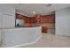 Bright kitchen with stainless steel refrigerator, granite countertops, breakfast bar, and generous cabinet storage at 20109 Bay Cedar Ave, Tampa, FL 33647