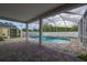 Relaxing covered pool with a brick deck and a jacuzzi offers a great space for fun and relaxation at 20109 Bay Cedar Ave, Tampa, FL 33647