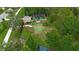 Aerial view of a community putting green with a small clubhouse and manicured landscaping at 20109 Bay Cedar Ave, Tampa, FL 33647