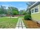 Backyard featuring a basketball court, walkway, and landscaped area at 204 W Calhoun St, Plant City, FL 33563