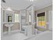 Bright bathroom with a soaking tub, pedestal sink, and tiled shower at 204 W Calhoun St, Plant City, FL 33563