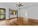 Inviting living room with hardwood floors, a ceiling fan, and a large window, providing a comfortable and stylish space at 204 W Calhoun St, Plant City, FL 33563