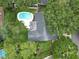 Overhead shot of property with pool and large trees, showcasing backyard privacy at 2273 Willowbrook Dr, Clearwater, FL 33764