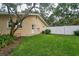 Private backyard featuring a well-manicured lawn, fencing, and mature trees providing shade and privacy at 2273 Willowbrook Dr, Clearwater, FL 33764