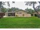 Spacious backyard with mature trees and well-maintained lawn, creating a peaceful and inviting outdoor retreat at 2273 Willowbrook Dr, Clearwater, FL 33764