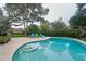 Backyard swimming pool with chairs, landscaped garden, and patio area at 2273 Willowbrook Dr, Clearwater, FL 33764